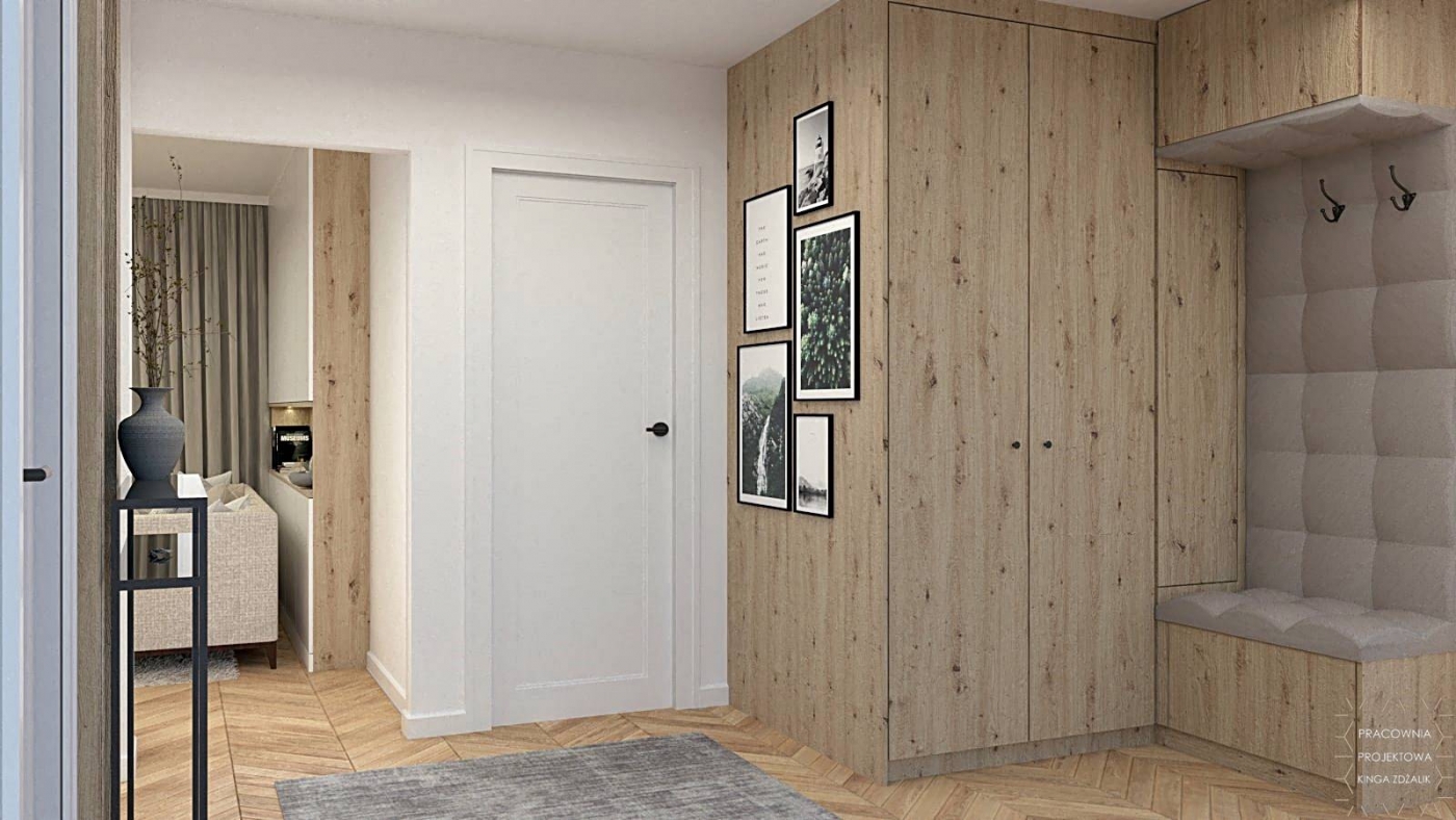 szafa w przedpokoju z ozdobnymi ramkami