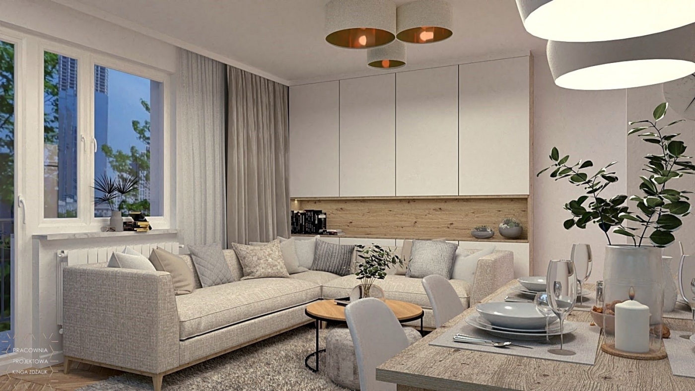 kanapa w salonie z szafkami oraz stolikiem